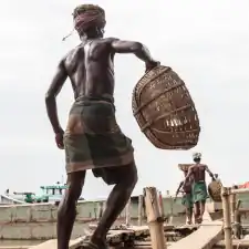 Bangladeshi men unloading goods from a river ship, a river quay on the east bank of Kirtonkhola River, Barisal District, Bangladesh, Indian Sub-Continent, Asia