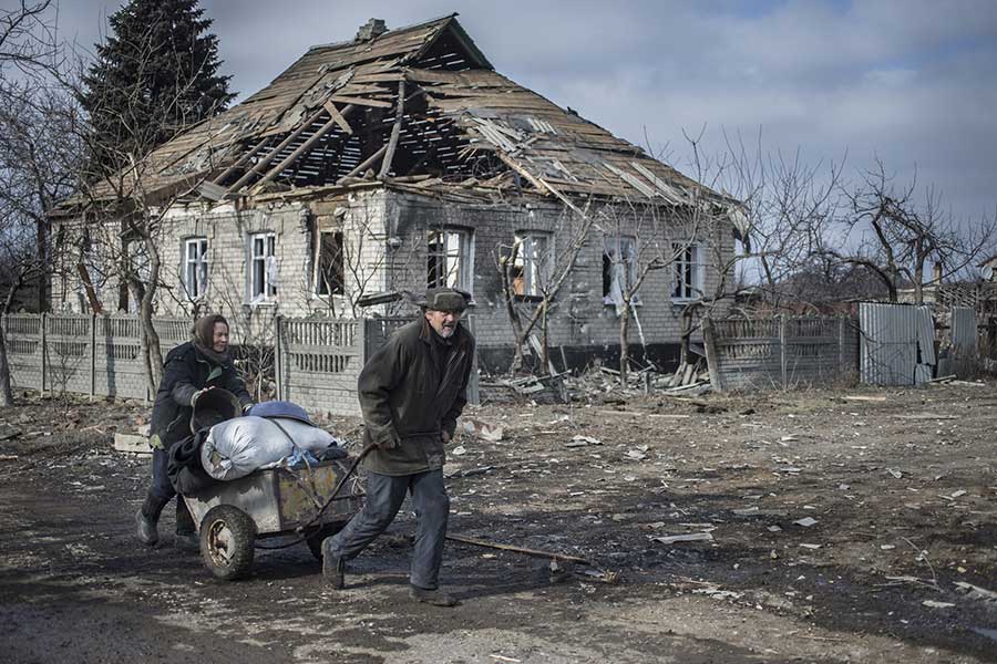 The battle for strategically important railway junction Debaltsevo was one of the fiercest of the entire war in Eastern Ukraine. Elderly pair on their way back to their house in Debaltsevo after picking up relief aid, Debaltsevo, Eastern Ukraine, February 20 2015 Photographer: Dmitri Beliakov/ for The Sunday Times