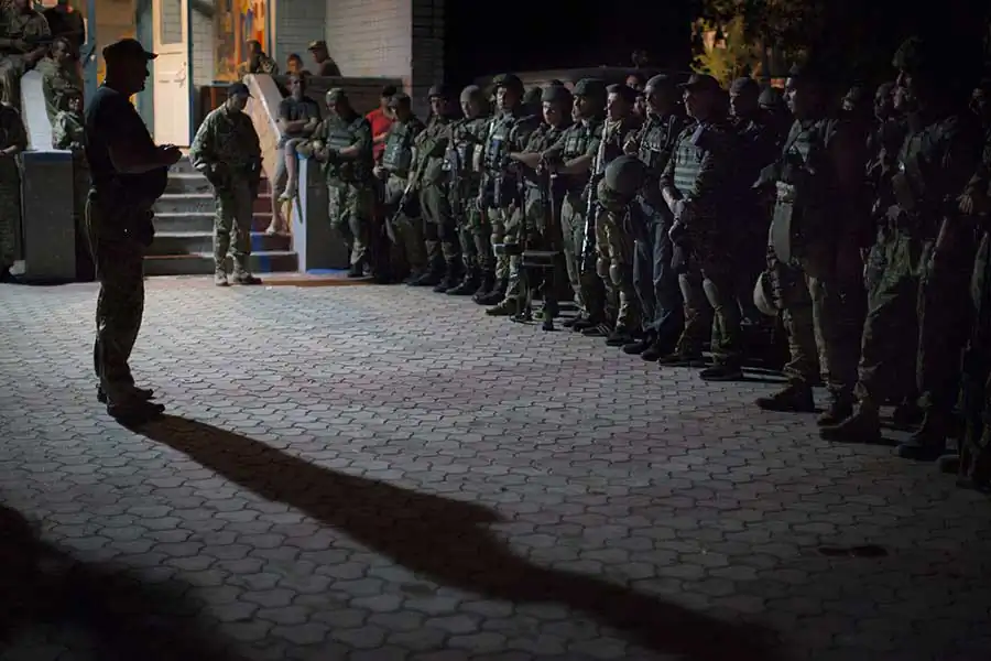 Colonel "Gal", the Commander of Ukrainian volunteer Special Force National Guard battalion "Donbas" sending final instructions to his fighters before night raid to the frontline.