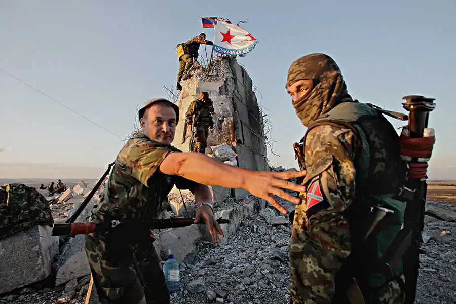 "Koleso", ex-miner, now pro-Russian separatists' group commander is overwhelmed with emotions as Russian navy flag being risen on his fighter's positions, retaken from the Ukrainian army after heavy fighting last week, August 30 2014, Savur-mohila hill, Eastern Ukraine.