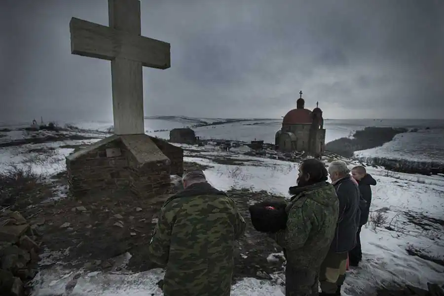 Pro-Russian militants pray before going frontline, Lutugino, Luhansk area, Ukraine, January 30 2015. Photographer: Dmitri Beliakov
