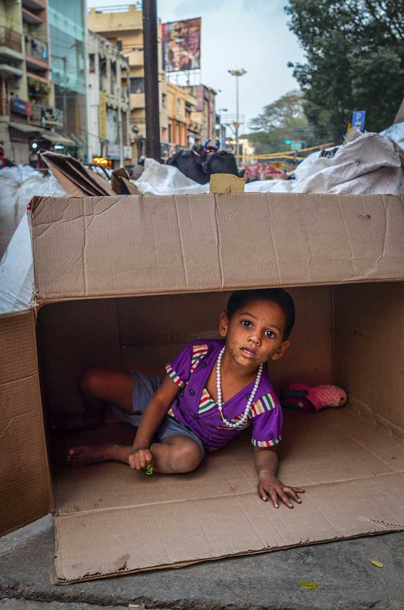A kid makes her own play area in descarded box