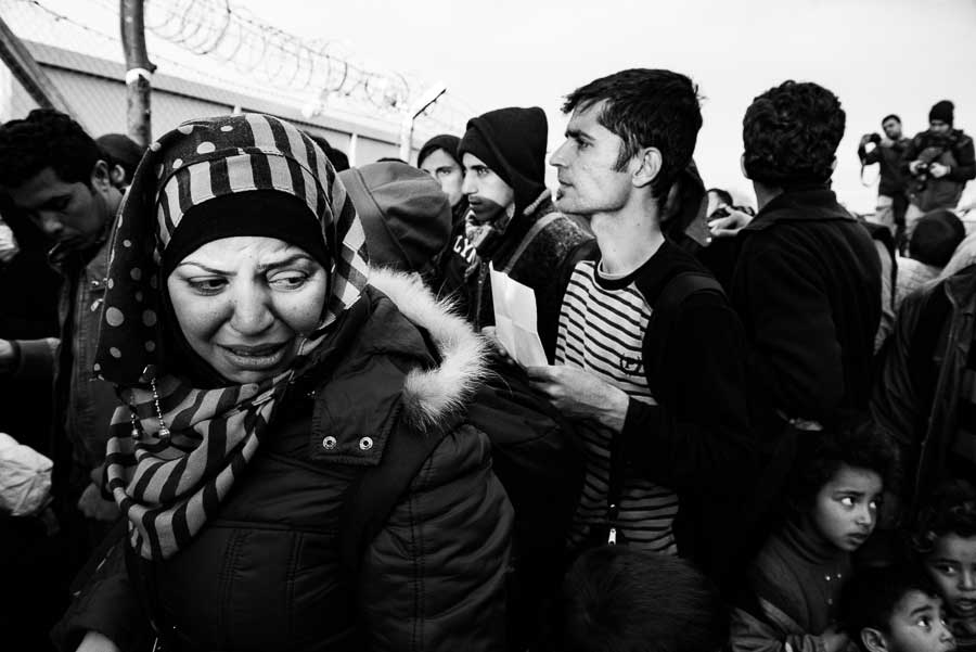 Refugees in the queue for checkpoint at the Greek- Macedonian border.