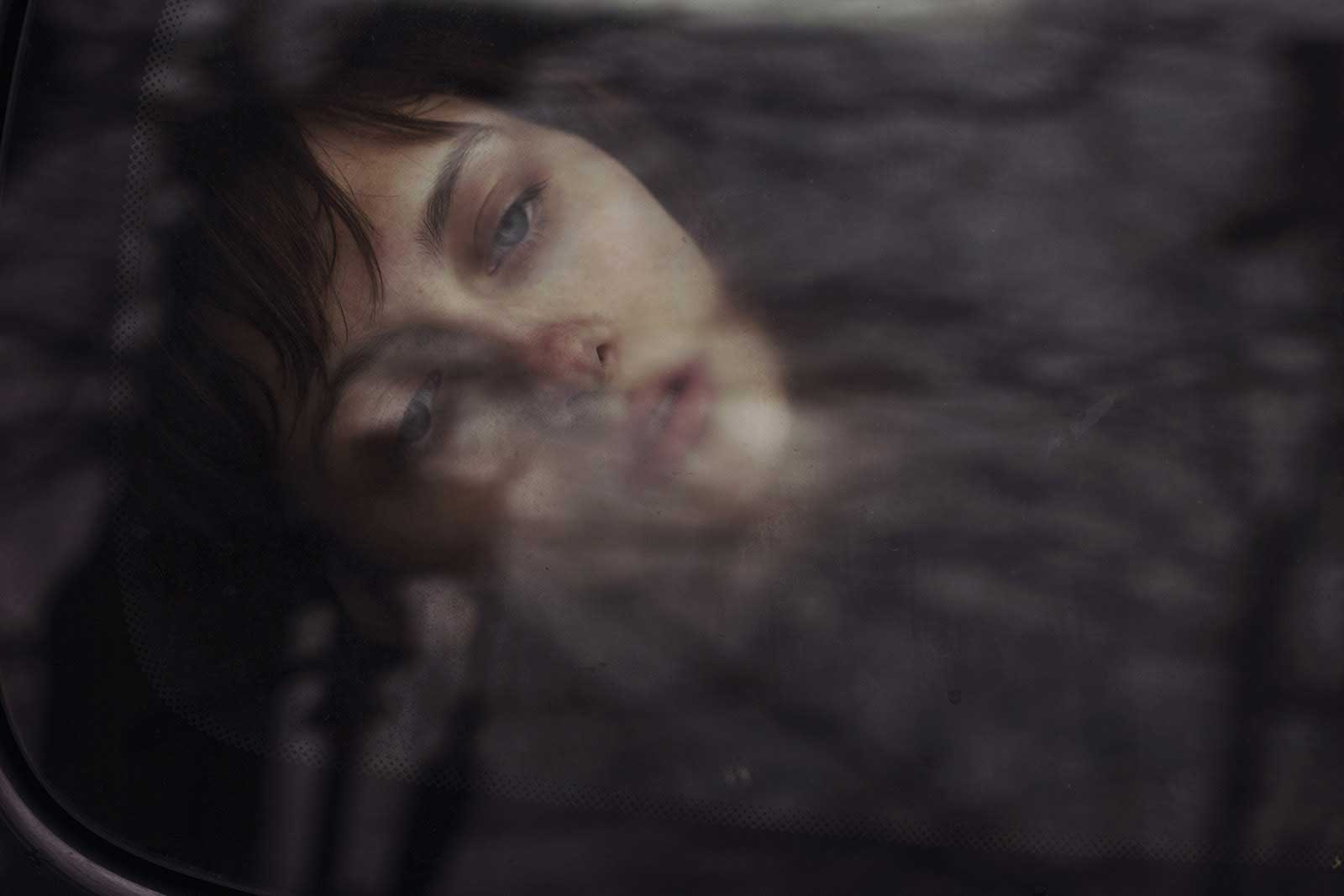 The dark sky and the tree branches reflected in the car window provided a moody atmosphere for this self portrait.