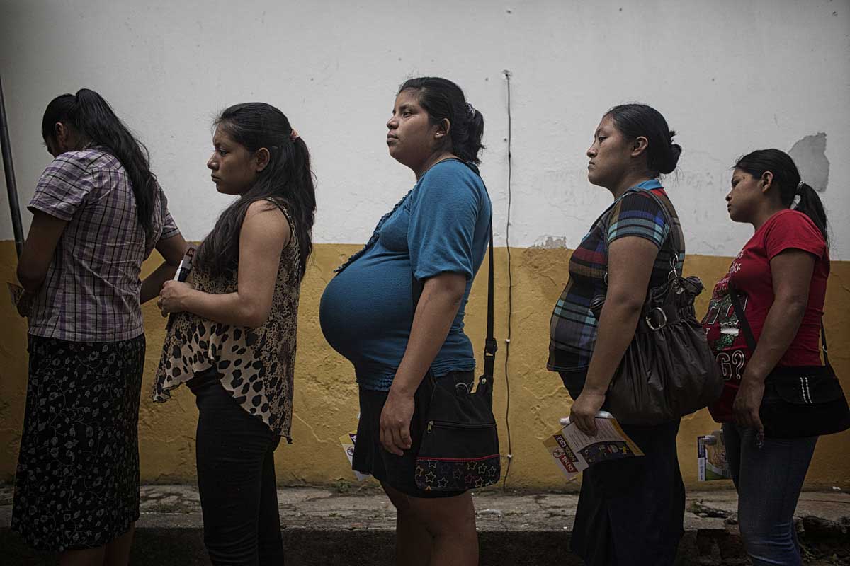 Planes de Renderos, El Salvador-May 2016: Pregnant women line up to receive mosquito repellent at the maternal waiting house in Planes de Renderos. The women were told they would receive repellent and mosquito nets at an event sponsored by the Canadian Embassy, WFP and the Ministry of Health however, after the press conference, the nets were reloaded into a truck and sent to a hospital. Pregnant women in today's El Salvador face a whole host of challenges from the threat of the mosquito born illness, Zika which has been linked to the grave condition of microcephaly in newborns, to the constant threat of gang violence with one of the highest murder rates in the world, to an increasing rape epidemic. However the most important threat to women's reproductive rights is by far the State's criminal ban on abortion. Doctors and nurses are trained to spy on women's uteruses in public hospitals, reporting any suspicious alteration to the authorities and provoking criminal charges which can lead to between 6 months to 7 years in prison. It is the poorer class of women who suffer the most as doctors in private hospitals are not required to report. Roughly 25 women are serving 30 to 40 year sentences on homicide charges for allegedly killing their newborn children. Although the women's stories, most of which resemble premature births or late term miscarigaes are often dismissed in trials, laced with moral accusations, based little on the consitution and scientific facts. ©Nadia Shira Cohen