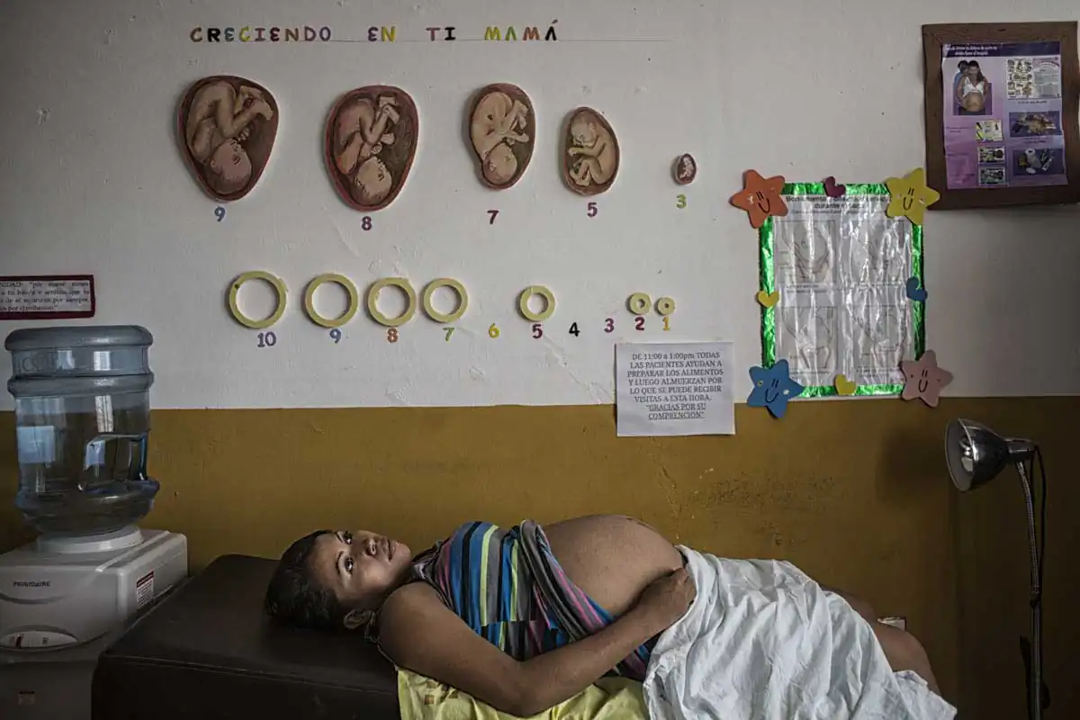 Planes de Renderos, El Salvador-May 2016: Abigail Sanches from San Luis Stalpa la Paz waiting to be examined at the maternal waiting house which especially helps women who come from areas without access to a nearby hospital wait out the end of the pregnancies in order to be close to a hospital and avoid complications. Pregnant women in today's El Salvador face a whole host of challenges from the threat of the mosquito born illness, Zika which has been linked to the grave condition of microcephaly in newborns, to the constant threat of gang violence with one of the highest murder rates in the world, to an increasing rape epidemic. However the most important threat to women's reproductive rights is by far the State's criminal ban on abortion. Doctors and nurses are trained to spy on women's uteruses in public hospitals, reporting any suspicious alteration to the authorities and provoking criminal charges which can lead to between 6 months to 7 years in prison. It is the poorer class of women who suffer the most as doctors in private hospitals are not required to report. Roughly 25 women are serving 30 to 40 year sentences on homicide charges for allegedly killing their newborn children. Although the women's stories, most of which resemble premature births or late term miscarigaes are often dismissed in trials, laced with moral accusations, based little on the consitution and scientific facts. ©Nadia Shira Cohen