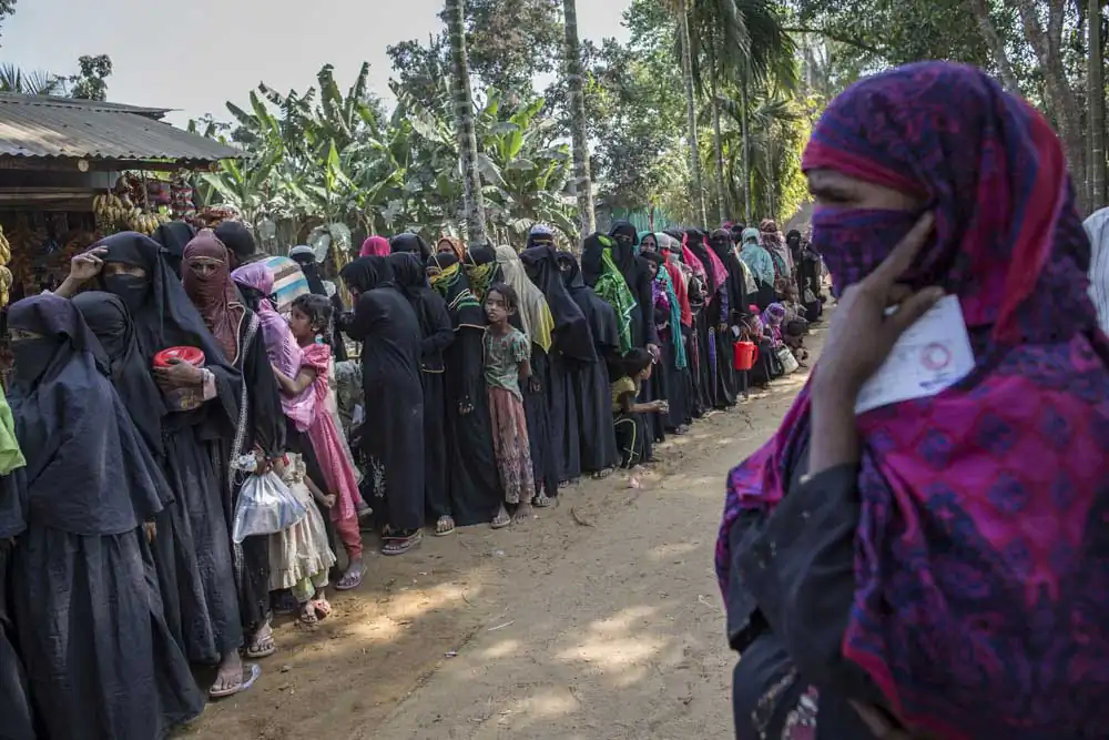 Rohingya refugees who recently fled from violence in Myanmar wait in a long food queue in Ukhia on March 5, 2017, Cox's Bazar.