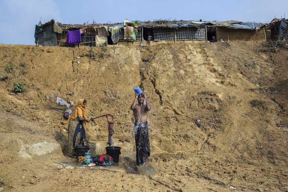 A refugee takes a bath in Kutapalong newly expanded Rohingya refugee camp.